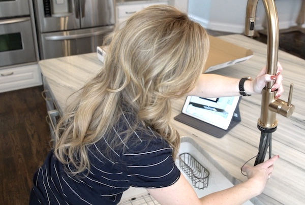 Woman assembling sink faucet